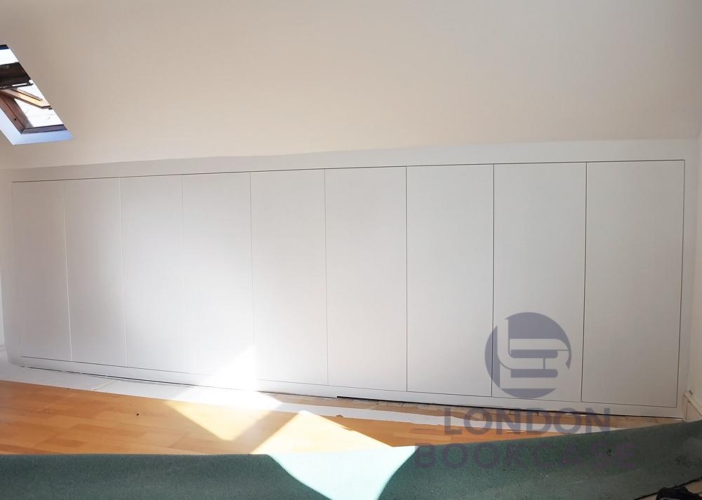 attic built-in cupboard system with push to open doors